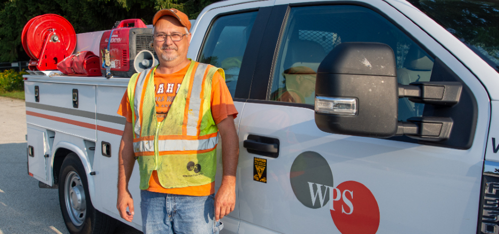 WPS employee Todd Siebold standing next to his work vehicle.