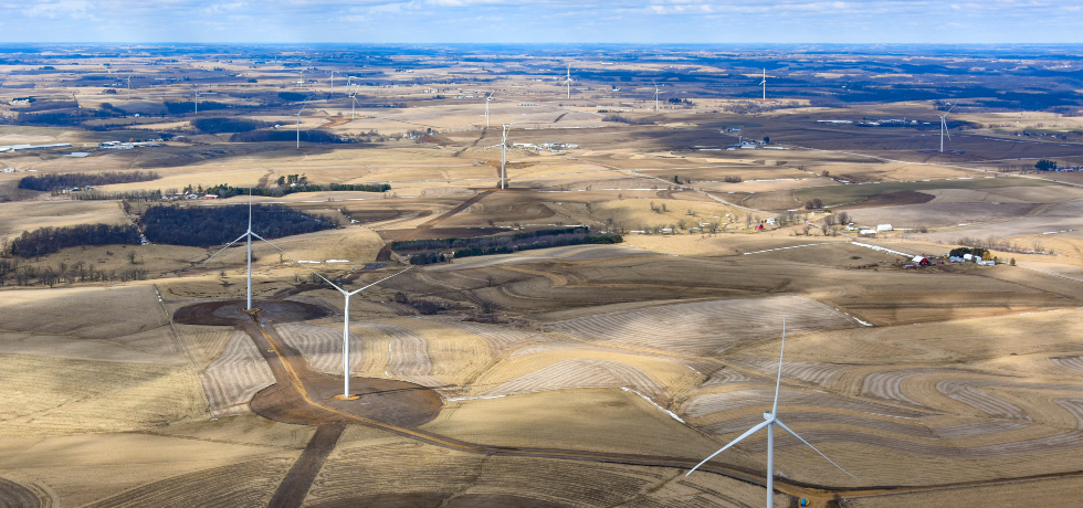 Red Barn Wind Park's wind turbines installed underneath a blue sky and among fields in southwest Wisconsin.