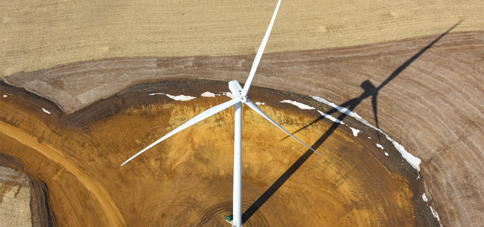 An overhead view of a wind turbine installed in a rural field at the Red Barn Wind Park