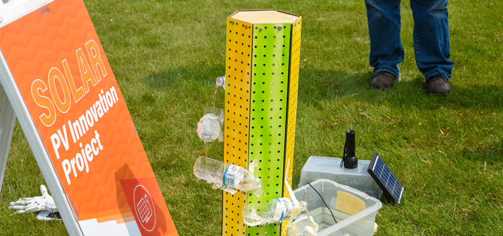 A green and yellow tower powered by a solar panel helps filter water as an entry in the WPS Solar Olympics PV Innovation event.