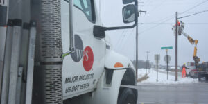 A WPS truck parked across from a lineworker crew restoring power.