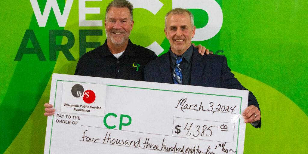 Two men hold up a ceremonial check being presented by the WPS Foundation as part of the CP Telethon.