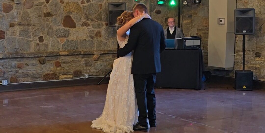 A bride and groom dancing together at their wedding.