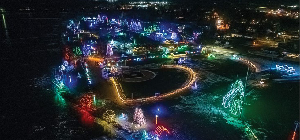 A overhead view of a holiday light display set in a park at night.