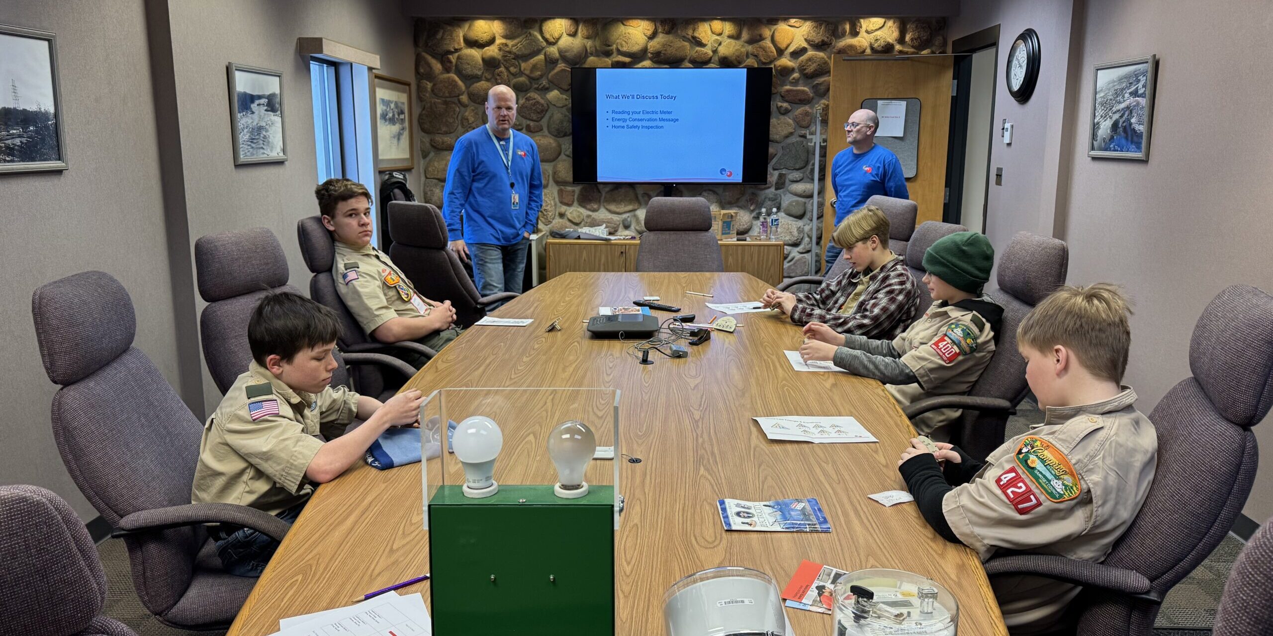 WPS employees speak with Scouts sitting at a long conference table.