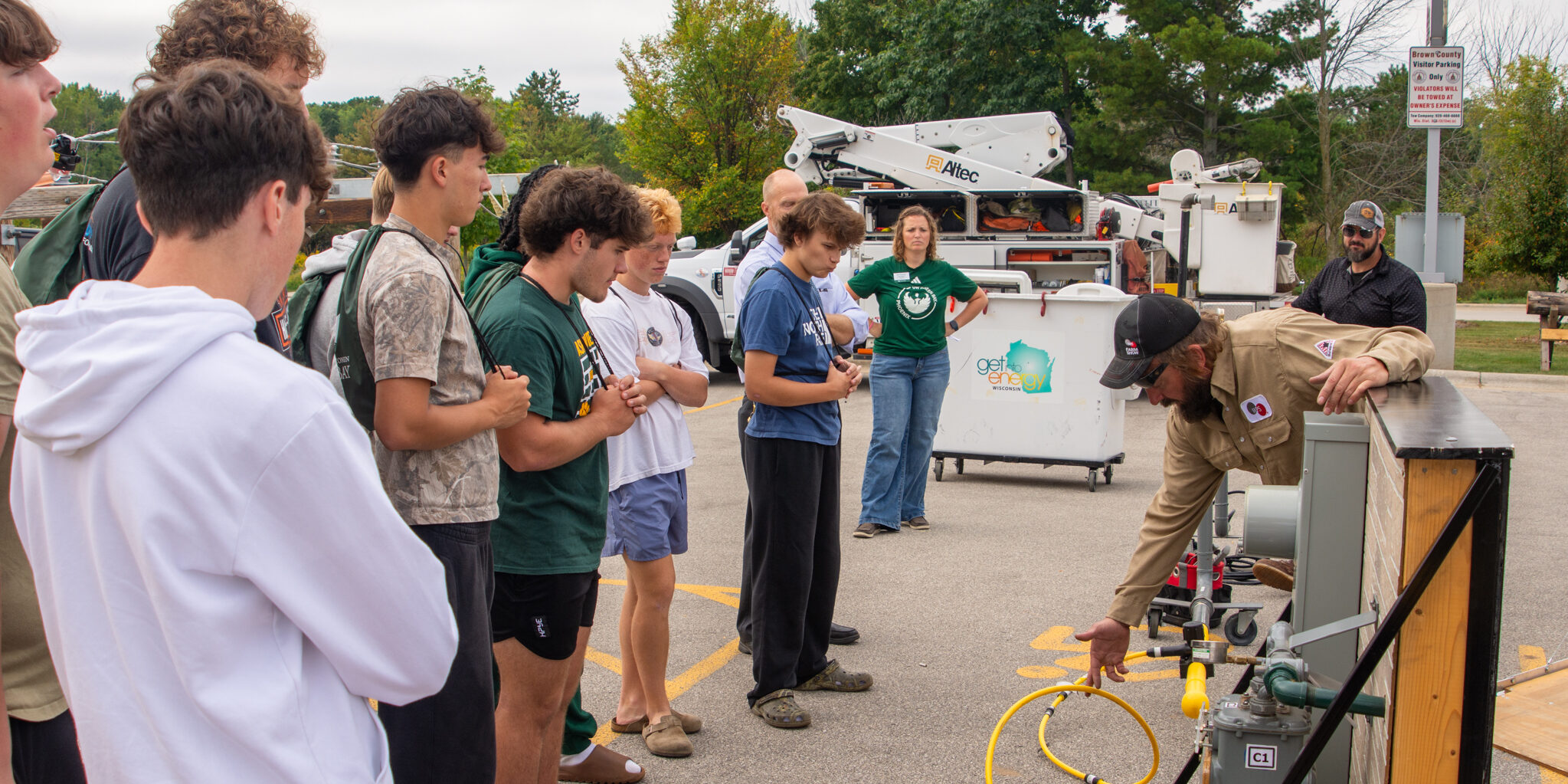 A WPS employee uses a mock system to show high school students how natural gas is delivered.