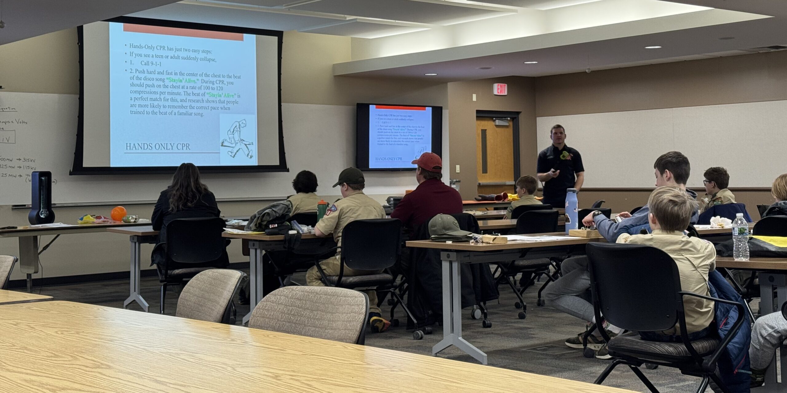 A member of the Wausau Fire Department teaches Scouts how to provide medical assistance if a nearby person is part of an emergency involving electricity.