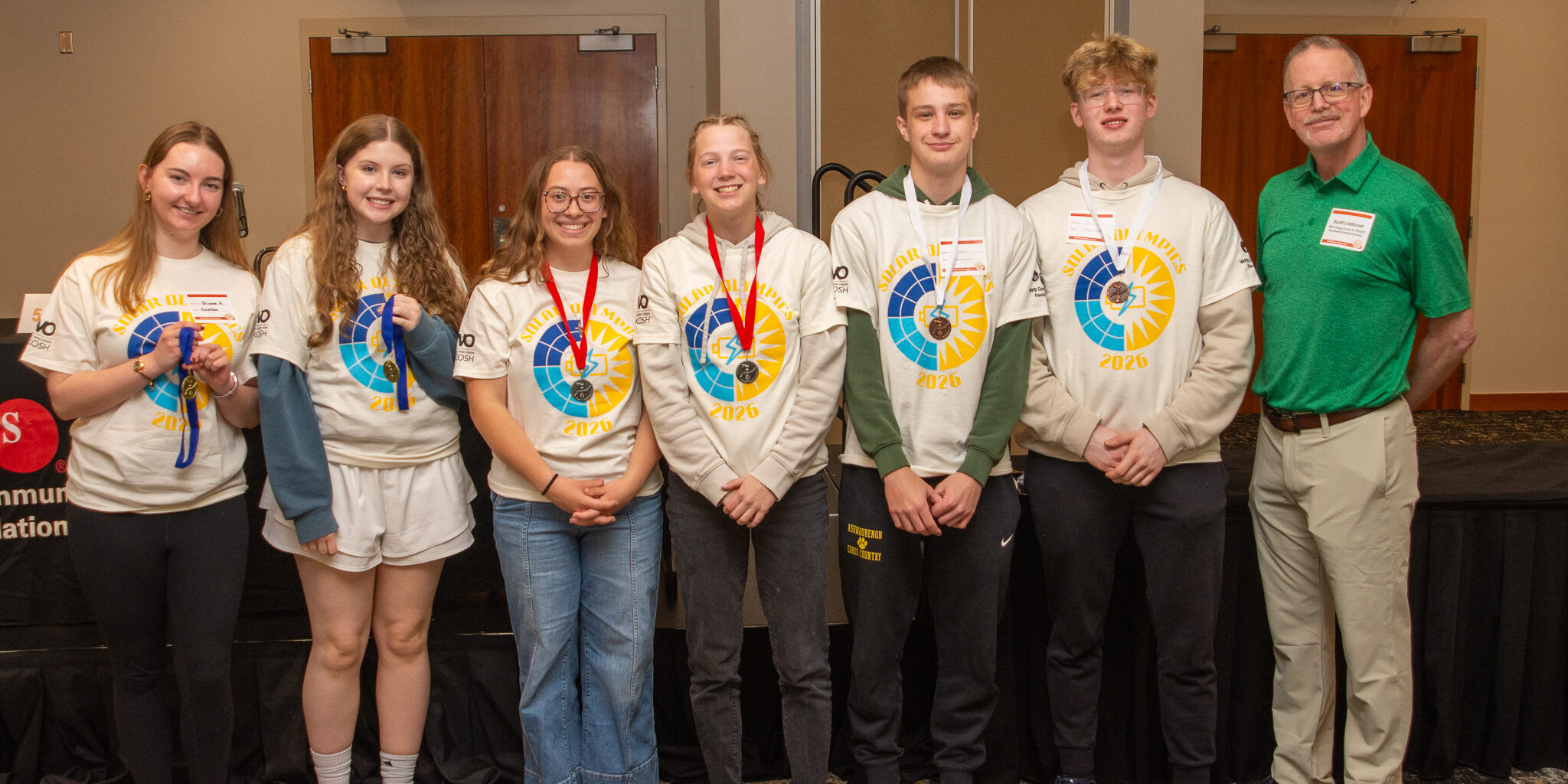 A group of high school students smiles for a photo with their medals during the 30th annual WPS Solar Olympics.