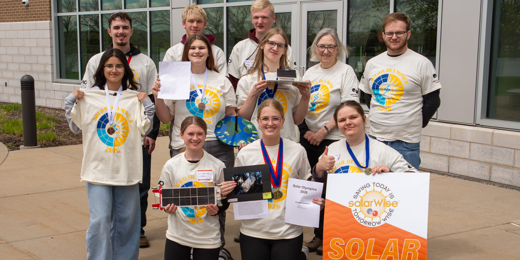 High school students take a team photo with their projects at the 30th annual WPS Solar Olympics.