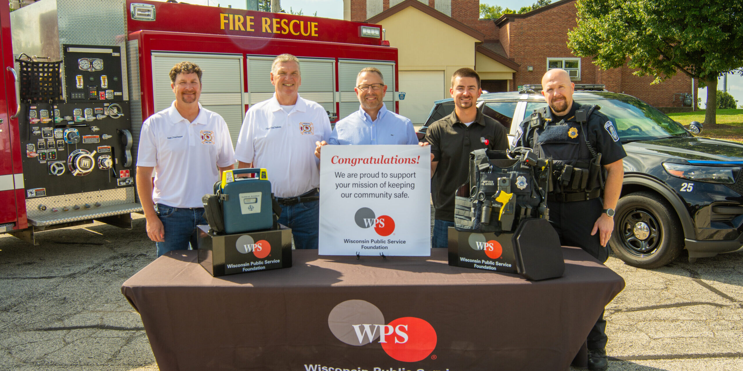 Luxemburg police officers and firefighters joined WPS representatives for a photo with examples of the lifesaving equipment they will acquire through the Rewarding Responders Grant program.